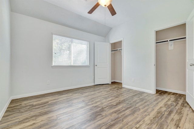 3807 Springcrest Ln, Montgomery, TX 77356 - unfurnished bedroom featuring multiple closets, wood finished floors, vaulted ceiling, baseboards, and ceiling fan