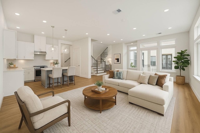 10927 Brookeshire Chase Ln, Houston, TX 77043 - living area featuring light wood-style floors, recessed lighting, stairway, and baseboards