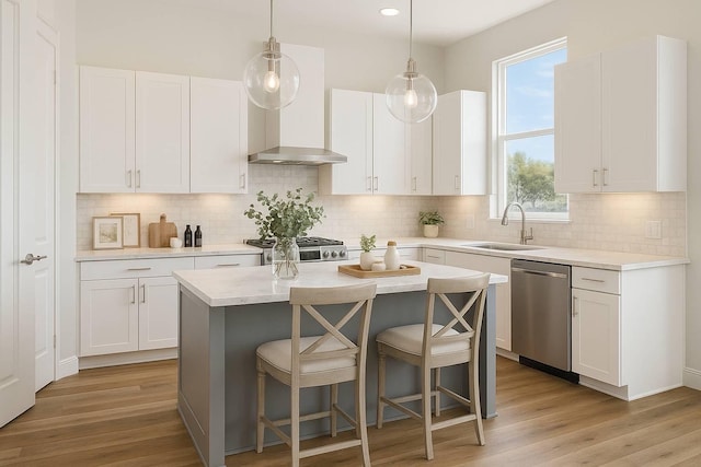 10927 Brookeshire Chase Ln, Houston, TX 77043 - kitchen with a sink, stainless steel dishwasher, wall chimney exhaust hood, a kitchen breakfast bar, and stove