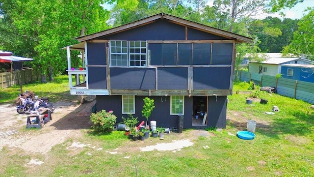 26643 Carol Ln, Splendora, TX 77372 - rear view of house with fence and a sunroom