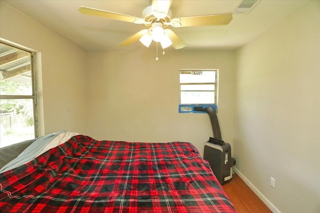 26643 Carol Ln, Splendora, TX 77372 - bedroom featuring wood finished floors, baseboards, and a ceiling fan