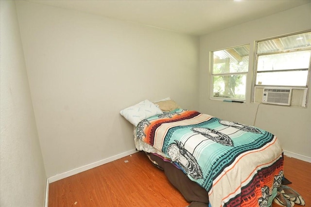 26643 Carol Ln, Splendora, TX 77372 - bedroom featuring wood finished floors, baseboards, and cooling unit