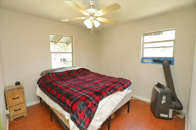 26643 Carol Ln, Splendora, TX 77372 - bedroom with wood finished floors, baseboards, and ceiling fan