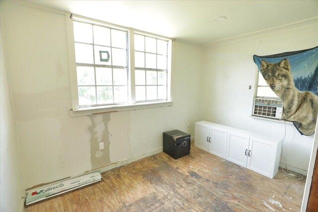26643 Carol Ln, Splendora, TX 77372 - spare room with wood finished floors, cooling unit, a baseboard radiator, and crown molding