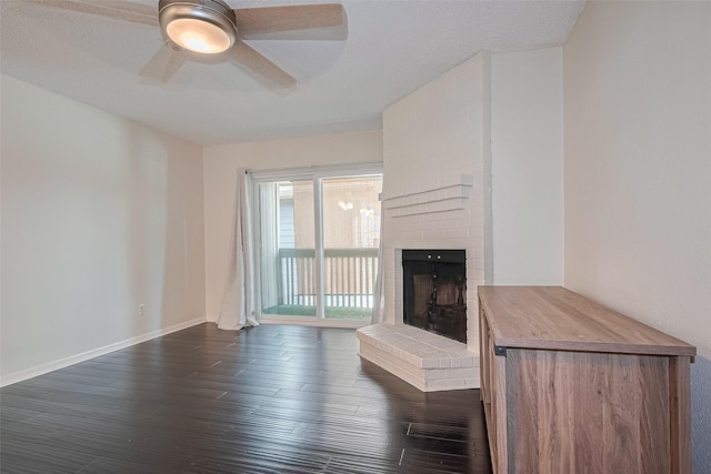 1900 Bay Area Blvd Unit 184, Houston, TX 77058 - unfurnished living room featuring dark wood finished floors, a fireplace, ceiling fan, and baseboards