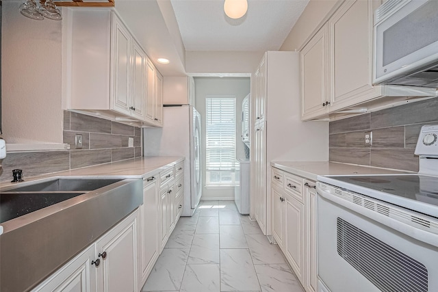 1900 Bay Area Blvd Unit 184, Houston, TX 77058 - kitchen with white appliances, light marble finish flooring, decorative backsplash, light countertops, and recessed lighting