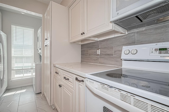 1900 Bay Area Blvd Unit 184, Houston, TX 77058 - kitchen featuring white appliances, light marble finish flooring, decorative backsplash, light stone countertops, and white cabinetry