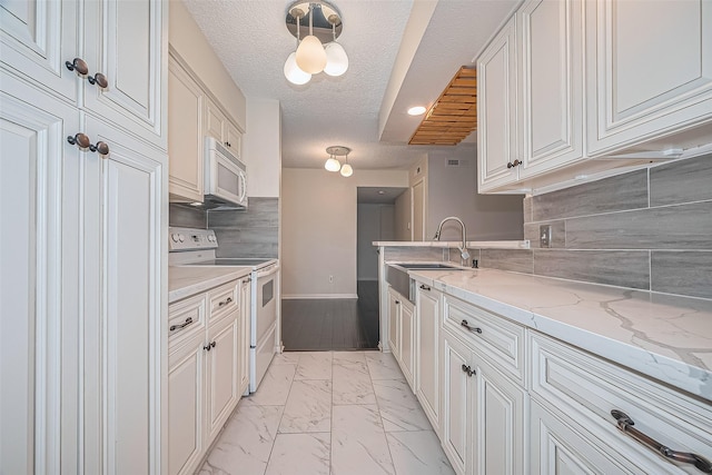 1900 Bay Area Blvd Unit 184, Houston, TX 77058 - kitchen featuring white appliances, a sink, light marble finish floors, baseboards, and decorative backsplash