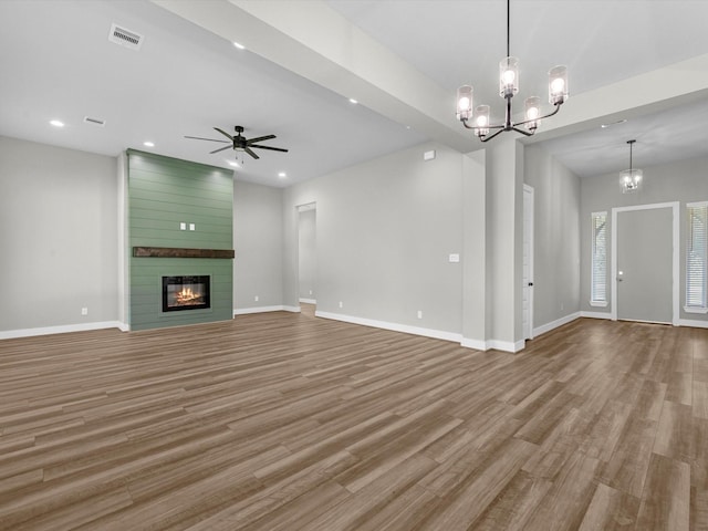 1462 Rd 66114, Dayton, TX 77535 - unfurnished living room with wood finished floors, baseboards, a chandelier, a fireplace, and recessed lighting