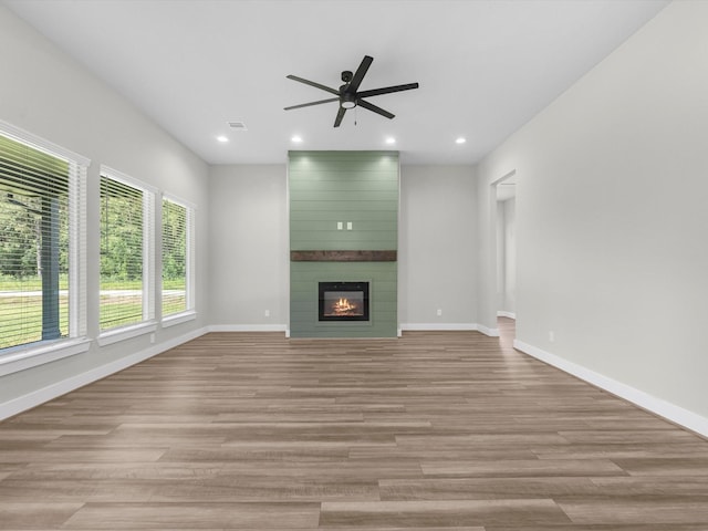 1462 Rd 66114, Dayton, TX 77535 - unfurnished living room featuring a ceiling fan, light wood-style flooring, baseboards, a large fireplace, and recessed lighting