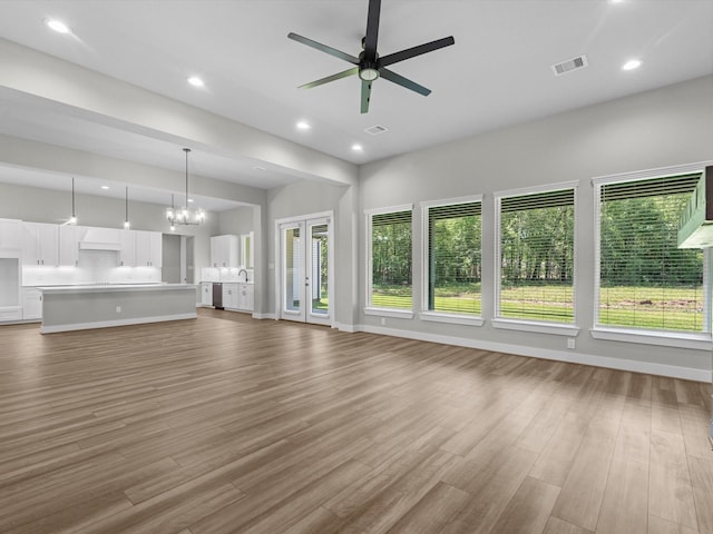 1462 Rd 66114, Dayton, TX 77535 - unfurnished living room with plenty of natural light, a ceiling fan, wood finished floors, and recessed lighting