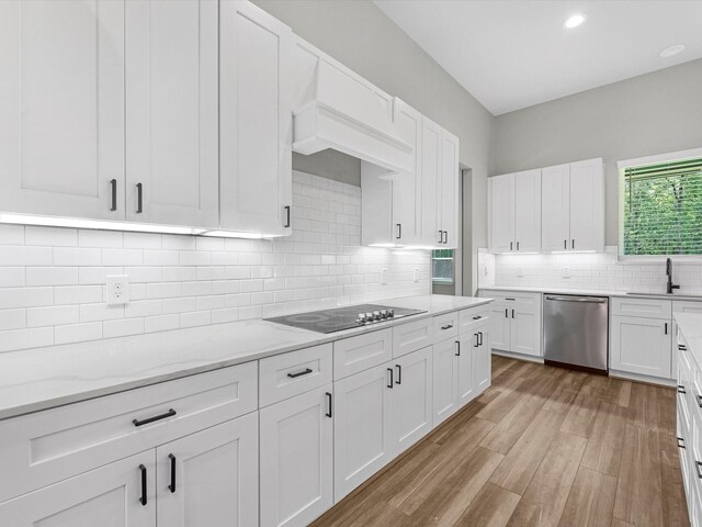 1462 Rd 66114, Dayton, TX 77535 - kitchen featuring stainless steel dishwasher, black electric cooktop, light wood-style flooring, white cabinets, and recessed lighting