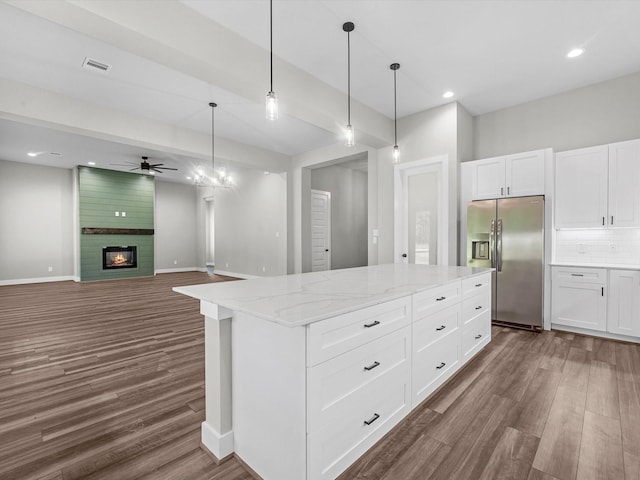 1462 Rd 66114, Dayton, TX 77535 - kitchen featuring stainless steel fridge, dark wood-type flooring, a ceiling fan, light stone countertops, and hanging light fixtures