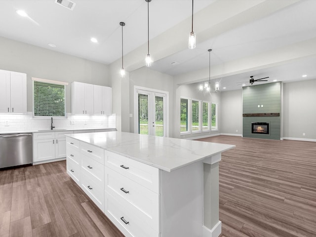 1462 Rd 66114, Dayton, TX 77535 - kitchen featuring dishwasher, a sink, wood finished floors, backsplash, and light stone countertops