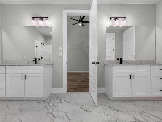 1462 Rd 66114, Dayton, TX 77535 - full bathroom featuring marble look tile flooring, a ceiling fan, a shower stall, baseboards, and two vanities
