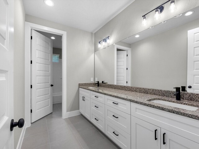 1462 Rd 66114, Dayton, TX 77535 - bathroom with baseboards, double vanity, tile patterned floors, and recessed lighting