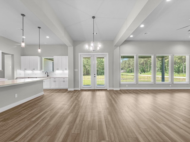 1462 Rd 66114, Dayton, TX 77535 - unfurnished living room featuring light wood-type flooring, a sink, baseboards, french doors, and recessed lighting