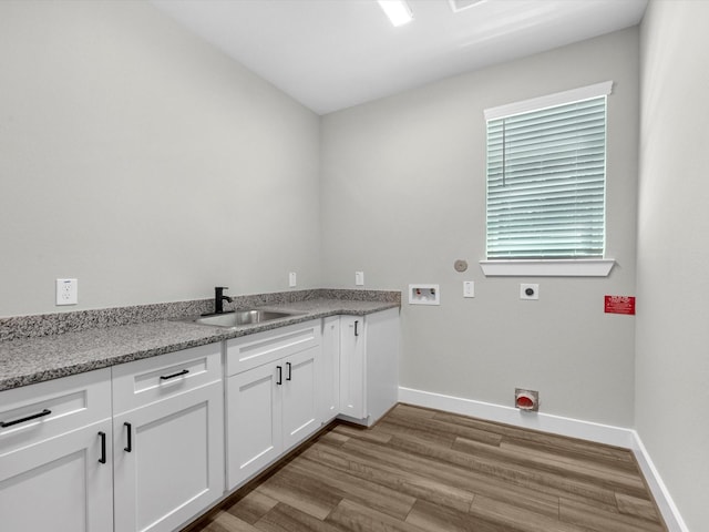 1462 Rd 66114, Dayton, TX 77535 - clothes washing area with hookup for an electric dryer, hookup for a washing machine, wood finished floors, baseboards, and cabinet space