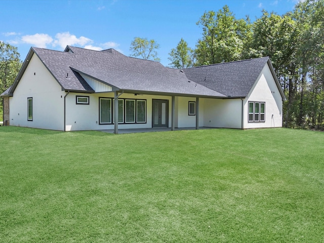 1462 Rd 66114, Dayton, TX 77535 - rear view of house with roof with shingles, a yard, and stucco siding