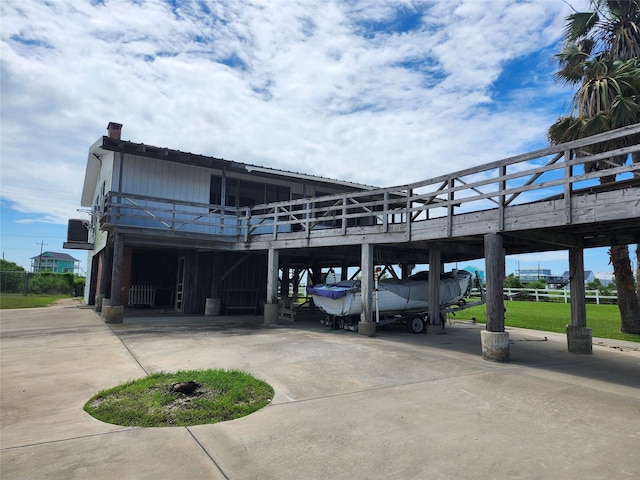 view of parking with curved driveway and a carport