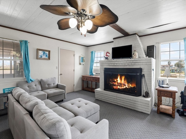 1134 Canal Dr, Surfside Beach, TX 77541 - carpeted living area with a fireplace, ceiling fan, and crown molding