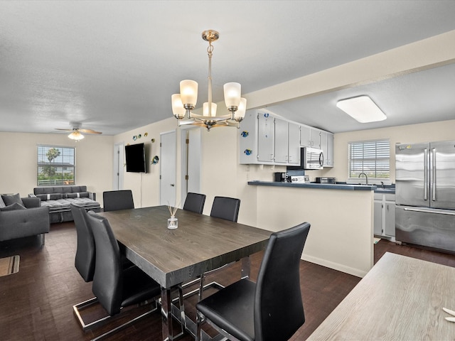 1134 Canal Dr, Surfside Beach, TX 77541 - dining space with plenty of natural light, a chandelier, dark wood-style flooring, and ceiling fan