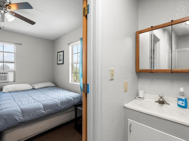 1134 Canal Dr, Surfside Beach, TX 77541 - bedroom with a ceiling fan, a textured wall, and cooling unit