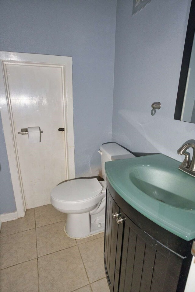 524 Oak Dr, Lake Jackson, TX 77566 - half bath featuring vanity, tile patterned flooring, and toilet