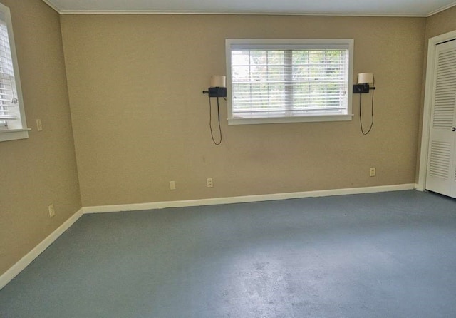 524 Oak Dr, Lake Jackson, TX 77566 - unfurnished room with baseboards, crown molding, and concrete flooring