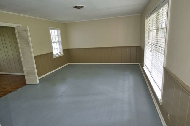 524 Oak Dr, Lake Jackson, TX 77566 - spare room with wainscoting and crown molding