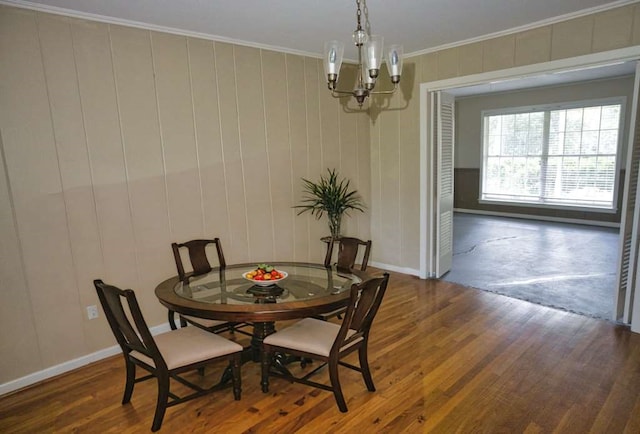 524 Oak Dr, Lake Jackson, TX 77566 - dining space with a chandelier, ornamental molding, wood finished floors, and baseboards