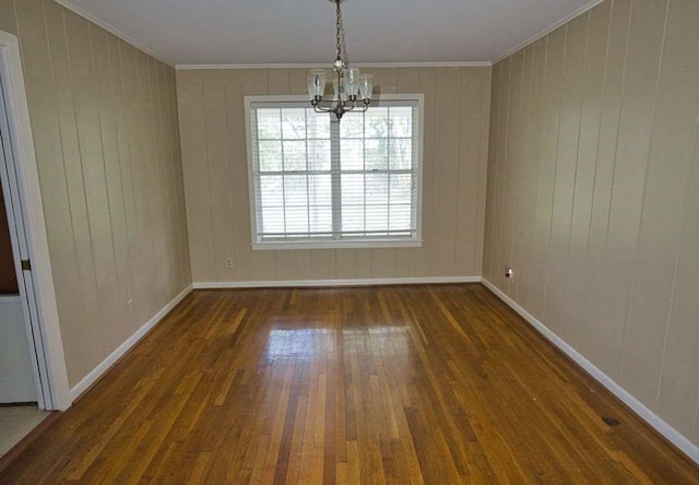 524 Oak Dr, Lake Jackson, TX 77566 - spare room with a chandelier, hardwood / wood-style floors, crown molding, baseboards, and wooden walls