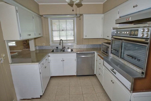 524 Oak Dr, Lake Jackson, TX 77566 - kitchen with appliances with stainless steel finishes, a sink, crown molding, light tile patterned floors, and ceiling fan