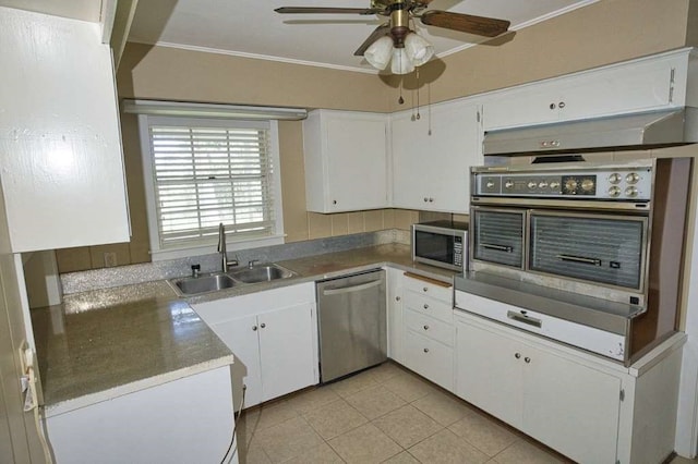 524 Oak Dr, Lake Jackson, TX 77566 - kitchen featuring stainless steel appliances, a sink, ornamental molding, a ceiling fan, and white cabinets