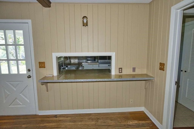 524 Oak Dr, Lake Jackson, TX 77566 - kitchen featuring a sink, wood finished floors, and wood walls