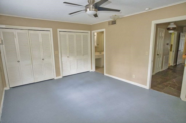 524 Oak Dr, Lake Jackson, TX 77566 - unfurnished bedroom featuring multiple closets, ornamental molding, baseboards, ensuite bath, and concrete flooring