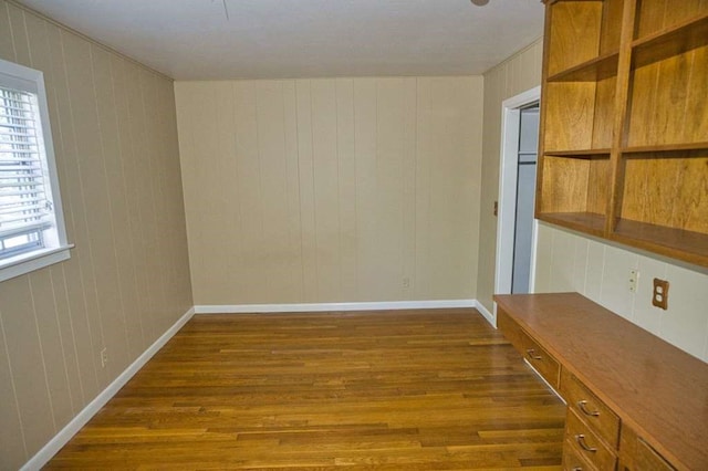 524 Oak Dr, Lake Jackson, TX 77566 - unfurnished dining area with dark wood-style floors and baseboards