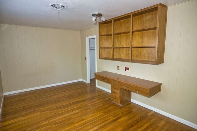 524 Oak Dr, Lake Jackson, TX 77566 - kitchen with dark wood-style floors, baseboards, open shelves, wooden walls, and dark countertops