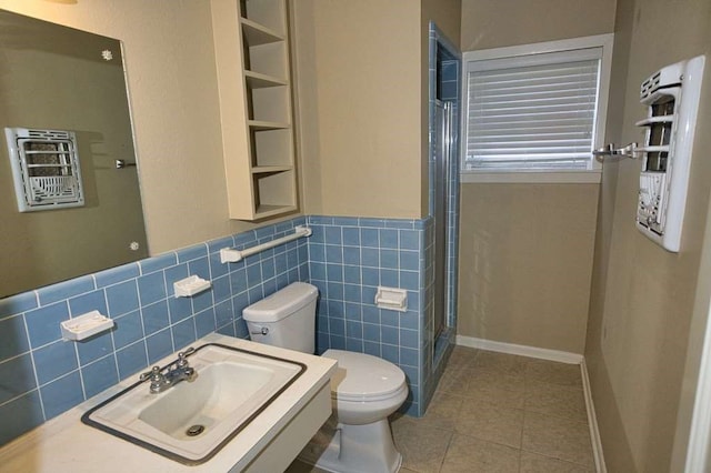 524 Oak Dr, Lake Jackson, TX 77566 - full bathroom featuring tile walls, toilet, tile patterned floors, a stall shower, and wainscoting