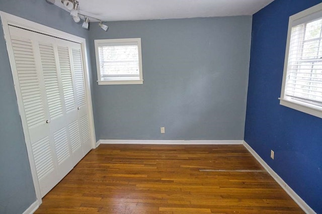 524 Oak Dr, Lake Jackson, TX 77566 - unfurnished bedroom with wood finished floors, a closet, and baseboards