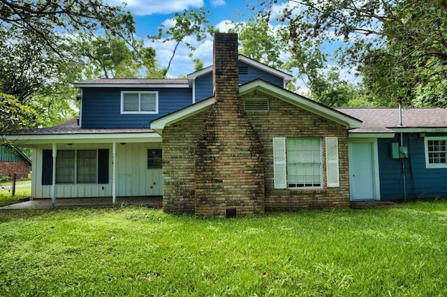 524 Oak Dr, Lake Jackson, TX 77566 - rear view of property with a chimney, a lawn, board and batten siding, and a shingled roof