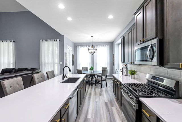 4302 Stoney Heights Ct, Spring, TX 77388 - kitchen with stainless steel appliances, a sink, light wood-style floors, light countertops, and recessed lighting