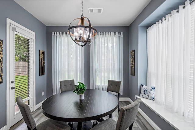 4302 Stoney Heights Ct, Spring, TX 77388 - dining area with a chandelier, wood finished floors, and baseboards