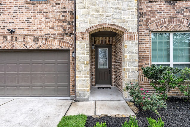 4302 Stoney Heights Ct, Spring, TX 77388 - view of exterior entry with brick siding, a garage, and driveway