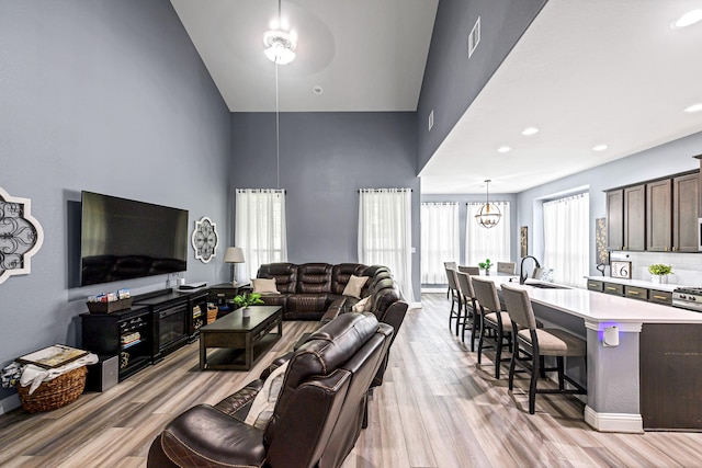 4302 Stoney Heights Ct, Spring, TX 77388 - living room featuring high vaulted ceiling, light wood finished floors, and baseboards