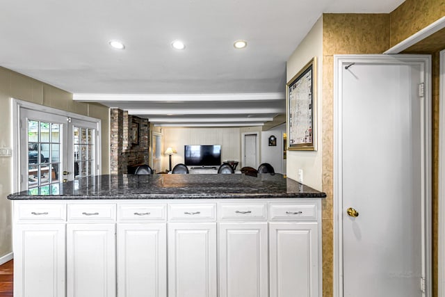 12726 Pebblebrook Dr, Houston, TX 77024 - kitchen featuring white cabinetry, dark stone counters, beam ceiling, open floor plan, and recessed lighting