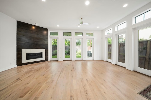 unfurnished living room with recessed lighting, a fireplace, light wood-style floors, and ceiling fan
