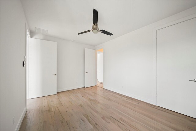 unfurnished bedroom featuring light wood finished floors, baseboards, and ceiling fan