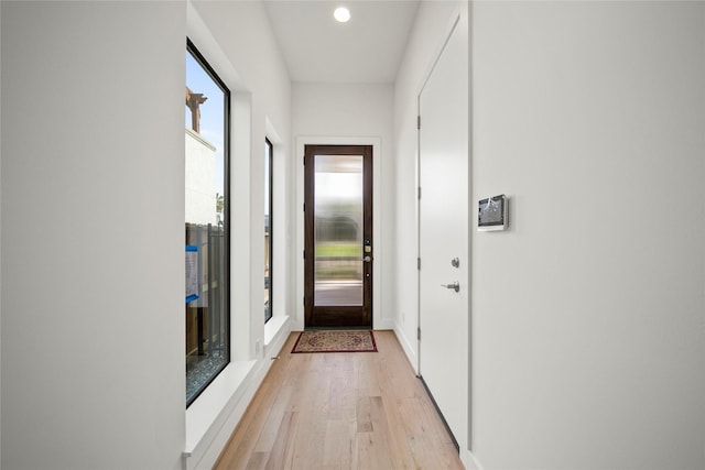 entryway featuring light wood finished floors, recessed lighting, and baseboards