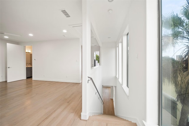 interior space featuring light wood-type flooring, recessed lighting, and baseboards